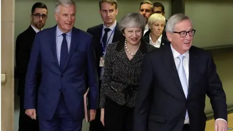 AFP Theresa May with Jean-Claude Juncker and Michel Barnier in Brussels