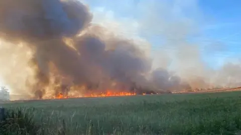 Heike Bailey Fire in crop field at Springbottom Farm, near Wilsford