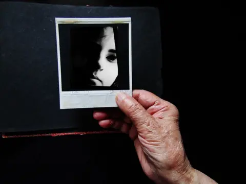 Preeti M Hand holding a photograph