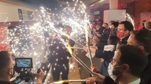 Staff holder sparklers as the train arrives
