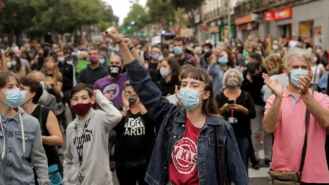 Reuters People protest over the lack of support and movement on improving working conditions at the Vallecas neighbourhood