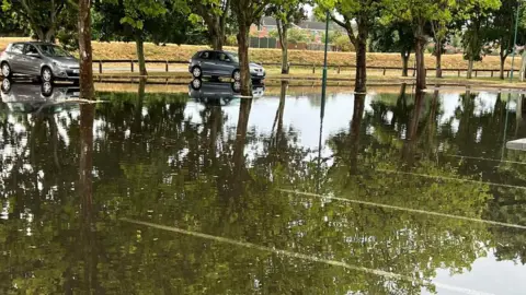 Sileby Volunteer Flood Wardens/PA Wire Flooding in a supermarket car park in car park in Loughborough