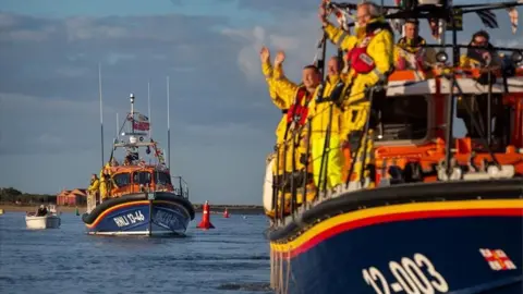 Leanne McColm RNLI crew wave to onlookers from on board lifeboats the Doris Mann of Ampthill and the Duke of Edinburgh