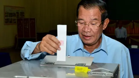 AFP/GETTY Hun Sen posting his vote in Kandal polling station