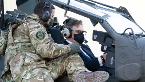 PA Media Jeremy Quin in a helicopter