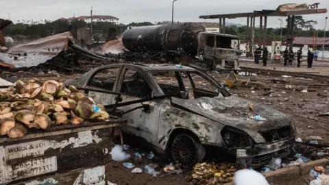 AFP A picture taken on October 8, 2017 in Accra shows burnt vehicles on the site where a gas tanker caught fire, triggering explosions at two fuel stations on the evening of October 7, 2017. At least three people were killed and dozens injured after a tanker truck carrying natural gas caught fire in Ghana"s capital, Accra, triggering explosions at two fuel stations, emergency services said on October 8, 2017. / A