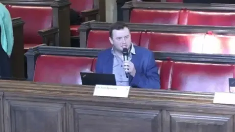 Bristol City Council Tom Renhard speaking into microphone