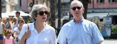 AFP Theresa May and her husband Philip in Italy