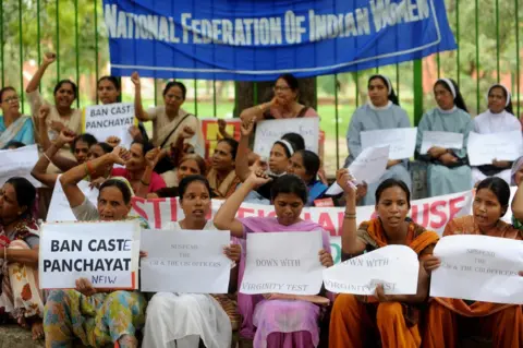 Getty Images Activists protest against virginity tests near the Indian parliament in Delhi in 2009