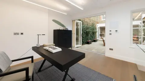 Savills The interior of a modern minimalist courtyard garden office