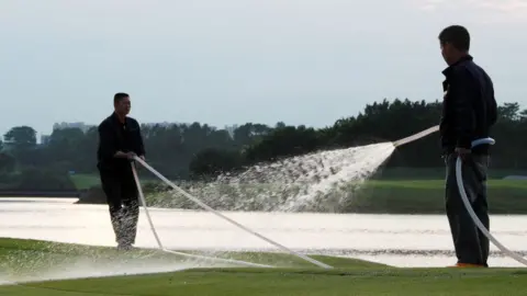 Getty Images people watering a golf course