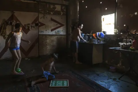 Tariq Zaidi A young family, residents of the abandoned IBGE building - an occupied squat. 'Favela' Mangueira community, Rio de Janeiro, Brazil