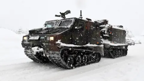 AFP A track vehicle of the German armed forces Bundeswehr drives through the snow to supply the cut off Buchenhoehe settlement area in Berchtesgaden, southern Germany, on January 10, 2019