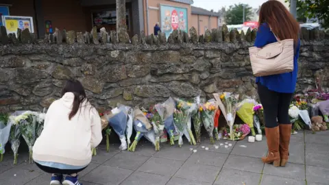 PA Media People leave flowers in the Keyham area of Plymouth after five people died in a shooting on 12 August 2021