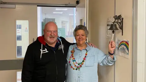 Family photo Sally Lee ringing the bell