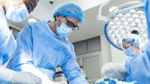 Getty Images Surgeons in an operating theatre