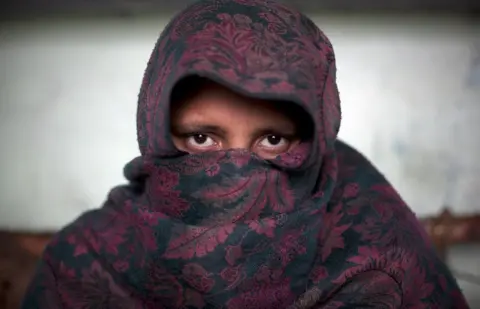 Getty Images A victim of gang-rape covers her face in the Shamli District of Uttar Pradesh