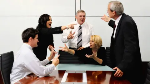 Getty Images People arguing in an office