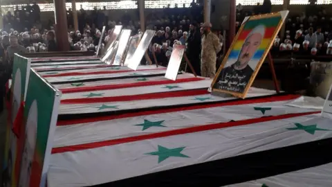 AFP Coffins lined up at a mass funeral for the Druze victims of the IS attack on the southern city of Suweida on 26 July 2018