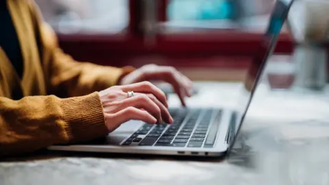 Getty Images Person types on a laptop