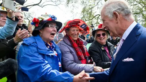PA Media Elizabeth Couzens, Jessie Young and Shirley Messinger with King Charles III