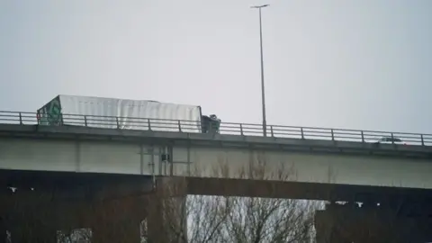 PA Media Overturned lorry on the M60