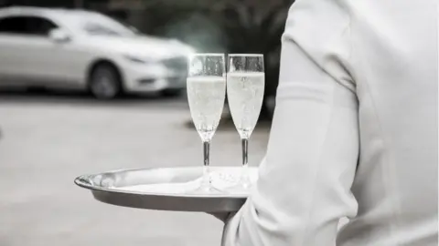 Getty Images Butler and champagne