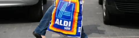 Getty Images shopper carries aldi carrier bag