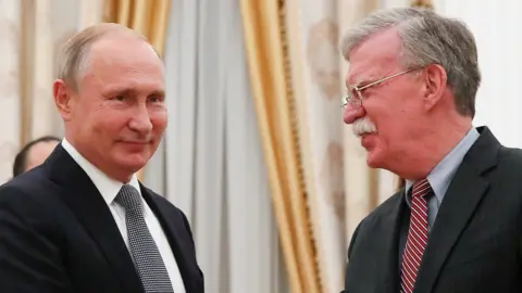 Reuters Vladimir Putin and John Bolton in Moscow in October 2018