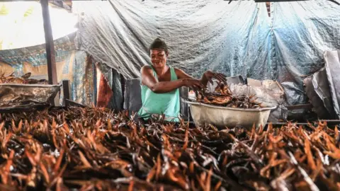 AFP Woman smoking fish, 8 September