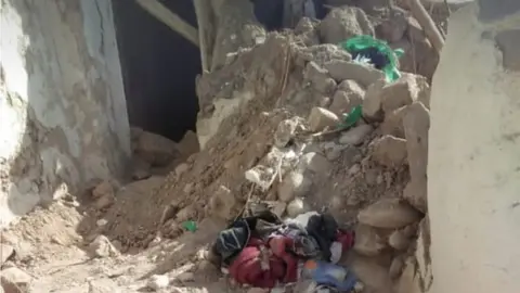 Karima Chiki Rubble piled up outside a home in Morocco