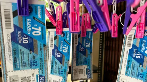 Getty Images Lottery tickets hang at a store