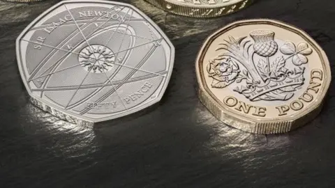 PA The new 50p Isaac Newton coin and the new £1 coin