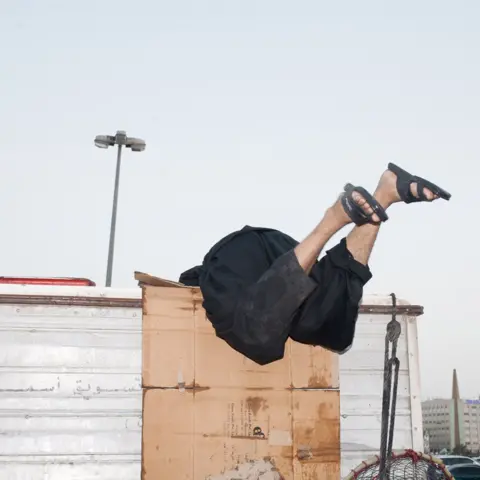 Olivia Arthur/Magnum Photos Workers unload sharks from vans at the Dubai Fish Market. 2013