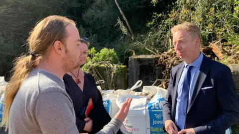 Alex Allison speaking to a Laxey resident