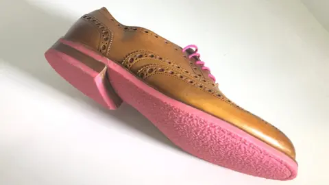 Shoe with pink sole made from chewing gum