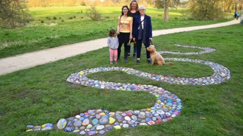 West Northamptonshire Council A dog on a lead, Anna Earnshaw, mural artist Sarah Hodgkins of Charlotte Designs Potterspury and Karyna Clifford with her daughter