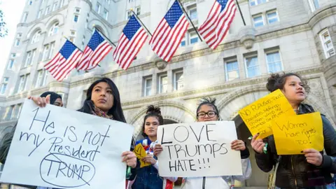 Getty Images Protesters outside the Trump International Hotel in Washington DC