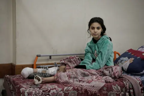 Mohammed Shahin/BBC Rafeef Dughmoush, whose leg was shattered by an airstike that killed 11 members of her family. (Mohammed Shahin/BBC)