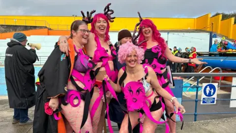 Barbara Thatcher Women in hot pink outfits with antlers