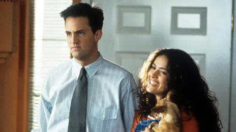 Getty Images Matthew Perry and Salma Hayek enter a home in a scene from the film 'Fools Rush In', 1997