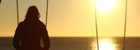 Getty Images Woman in sunset