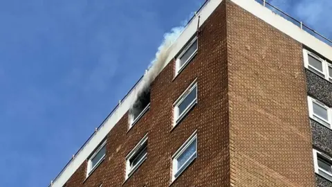 Smoke coming out from a Chadwell St Mary flat, in Essex