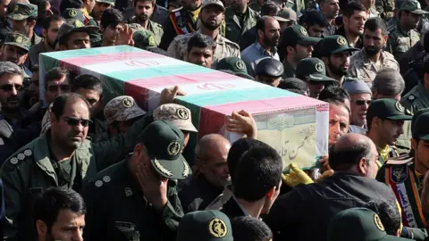 AFP Members of the Iranian Revolutionary Guards carry the casket of Brigadier General Mohsen Ghajarian, who was killed in Syria, in Tehran (6 February 2016)