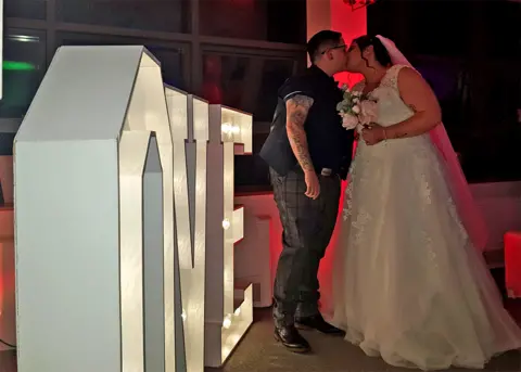 PA Media A wedding couple kiss