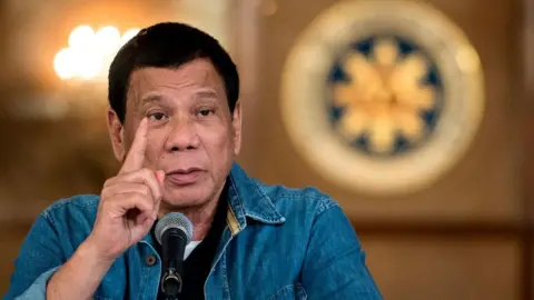 Getty Images Philippine President Rodrigo Duterte gestures as he answers a question during a press conference at the Malacanang palace in Manila