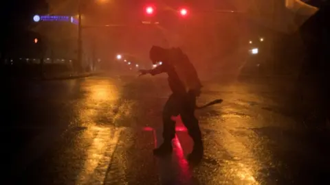 Reuters Stewart Adams, of San Marcos, Texas, battles the winds in Corpus Christi U.S. on 25 August, 2017