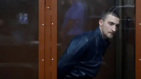 Reuters Pavel Ustinov, accused of using violence against an officer of Russia's National Guard during an unauthorised rally to demand free elections, attends a court hearing in Moscow.