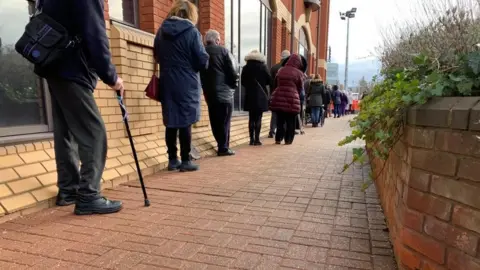 People queueing outside Robertson House in Stevenage for their vaccine