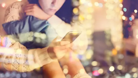 Getty Images Girl looking at mobile phone